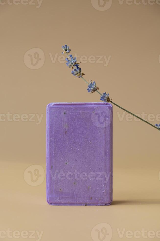 Lavender soap on beige background with copy space for your text. Advertisement template mock up. Skincare homemade natural cosmetic concept. Organic dry lavender flower. Handmade soap photo