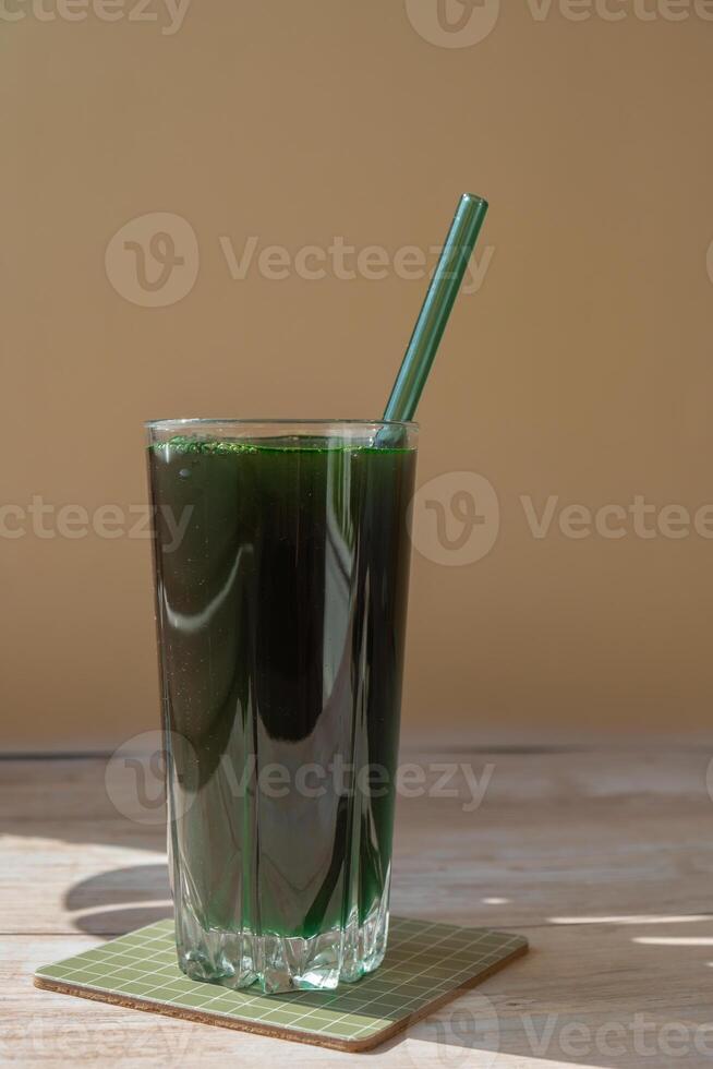 Organic blue-green algae spirulina detox drink in glass powder food. Health protein cocktail smoothie of chlorella. Vitamins and minerals to diet. Prebiotic and antioxidant rich Dietary supplement Seaweed superfood concept photo