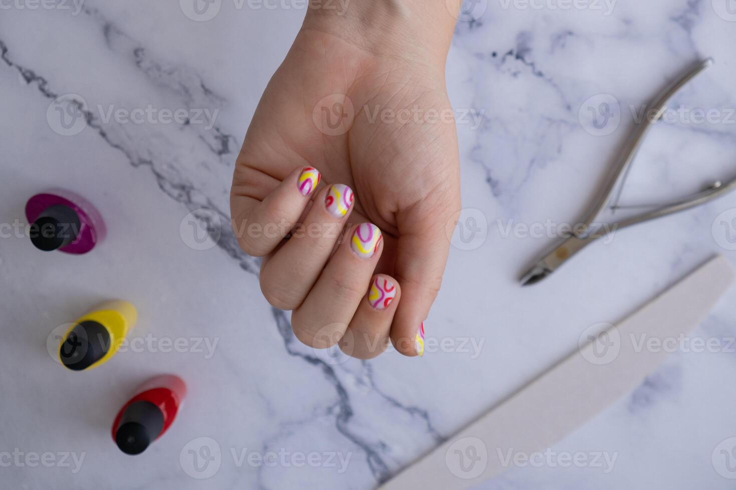 Pastel softness colorful manicured nails. Woman showing her new summer manicure in colors of pastel palette. Simplicity decor fresh spring vibes earth-colored neutral tones design photo