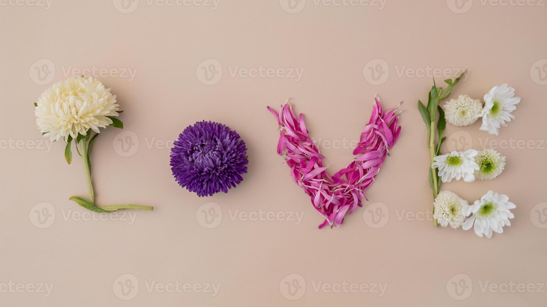 Word LOVE made of colorful flowers on feminine beige background. Concept of celebration holiday valentines day women day weeding anniversary. Greeting card minimalistic photo