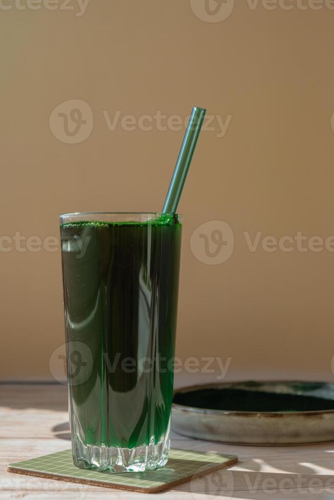 Organic blue-green algae spirulina detox drink in glass powder food. Health protein cocktail smoothie of chlorella. Vitamins and minerals to diet. Prebiotic and antioxidant rich Dietary supplement Seaweed superfood concept photo