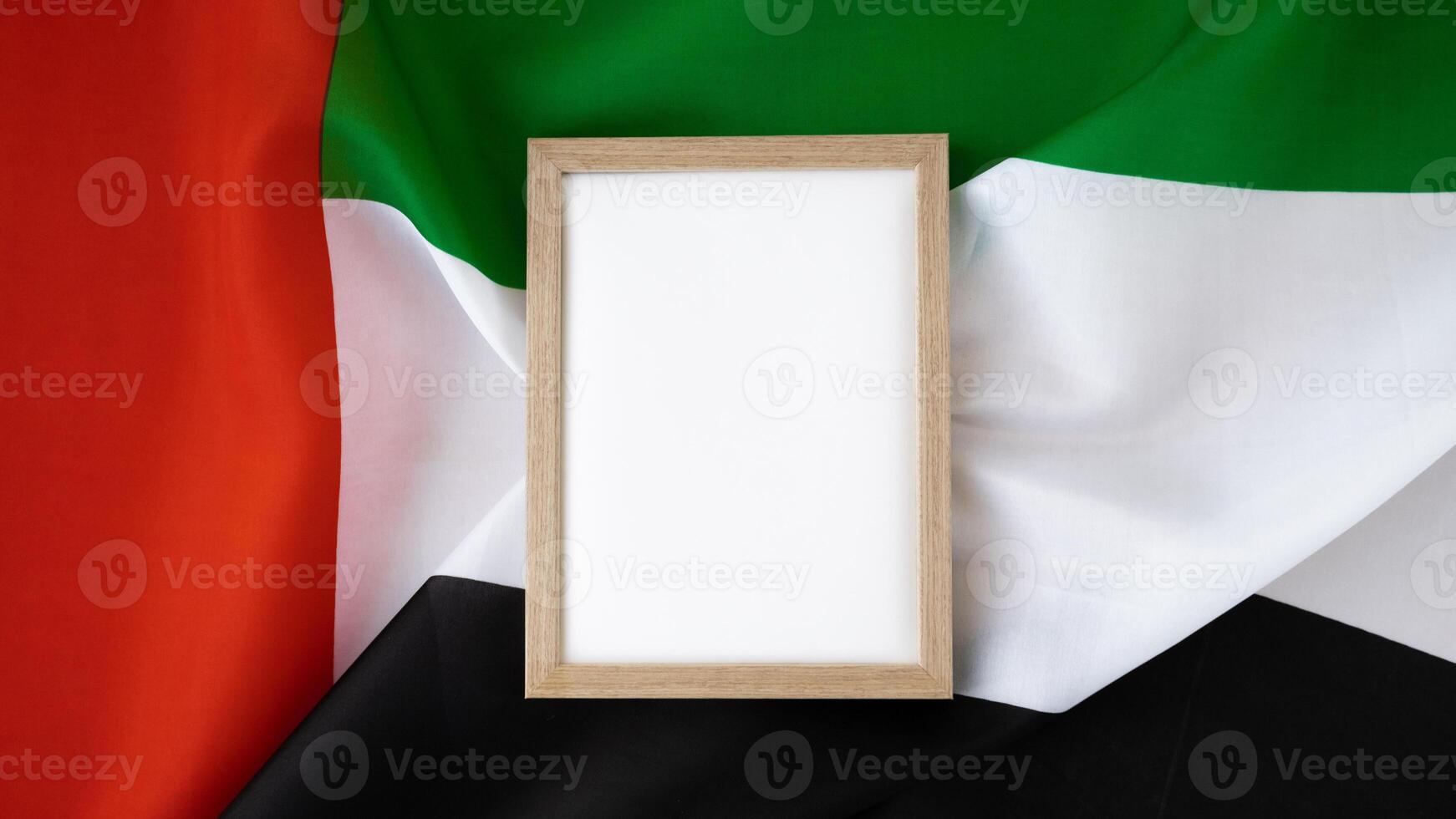 Empty white paper frame template National symbol of UAE. United Arab Emirates small flag with Peregrine falcon on neutral beige background. Copy space for your text. Concept of National day Independence photo