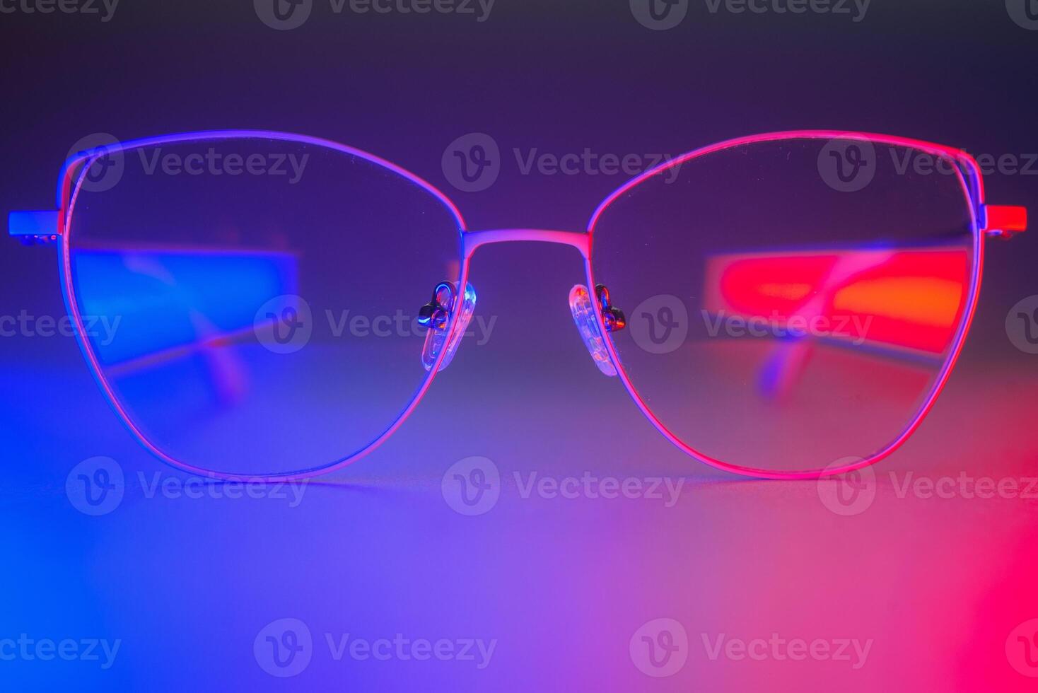 Stylish glasses shot using pink and blue abstract colored lighting with copy space. photo
