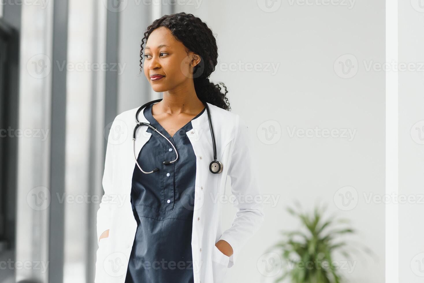 Portrait of female African American doctor standing in her office at clinic. photo