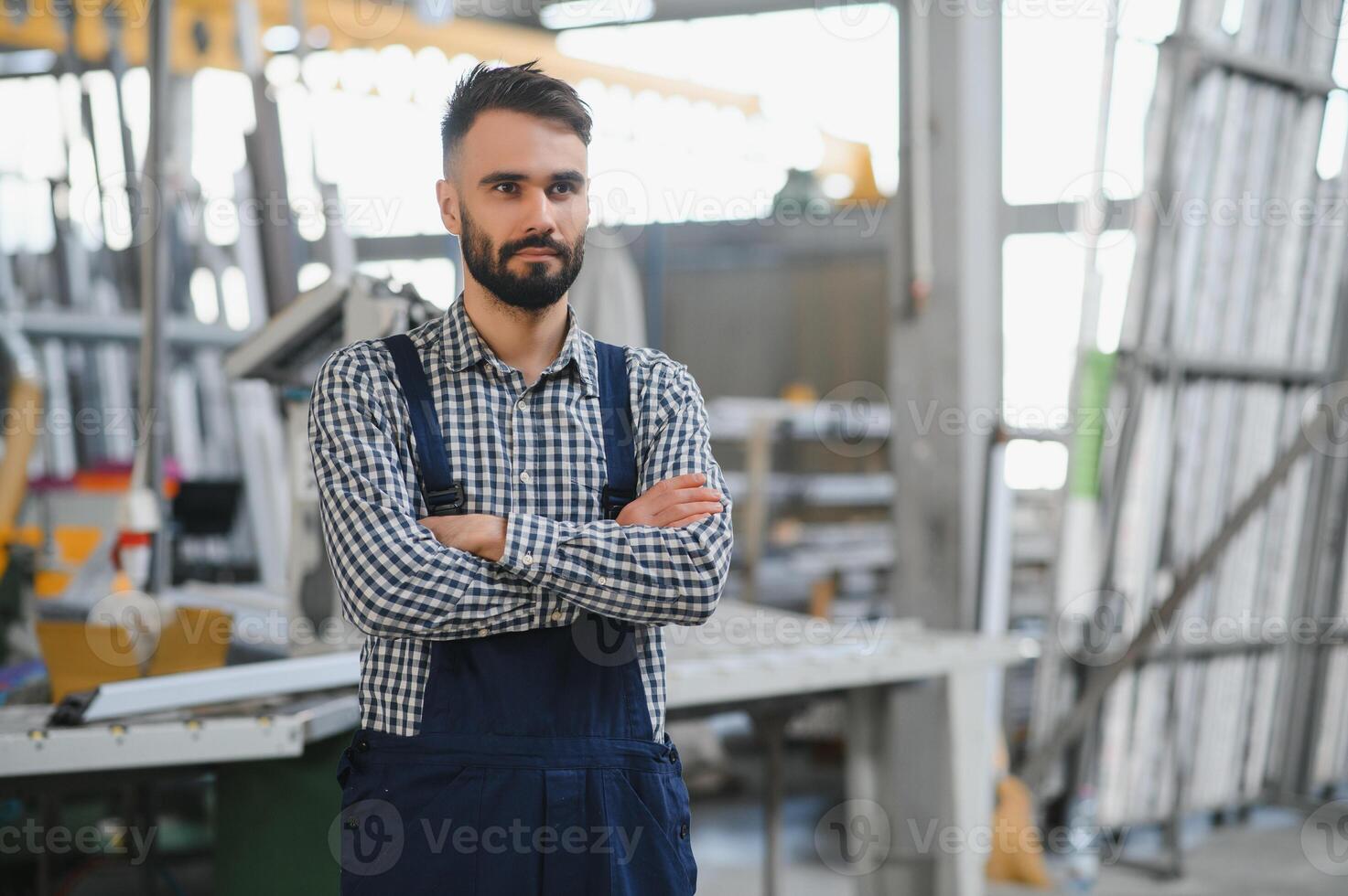 Portrait of factory worker in protective equipment in production hall. photo