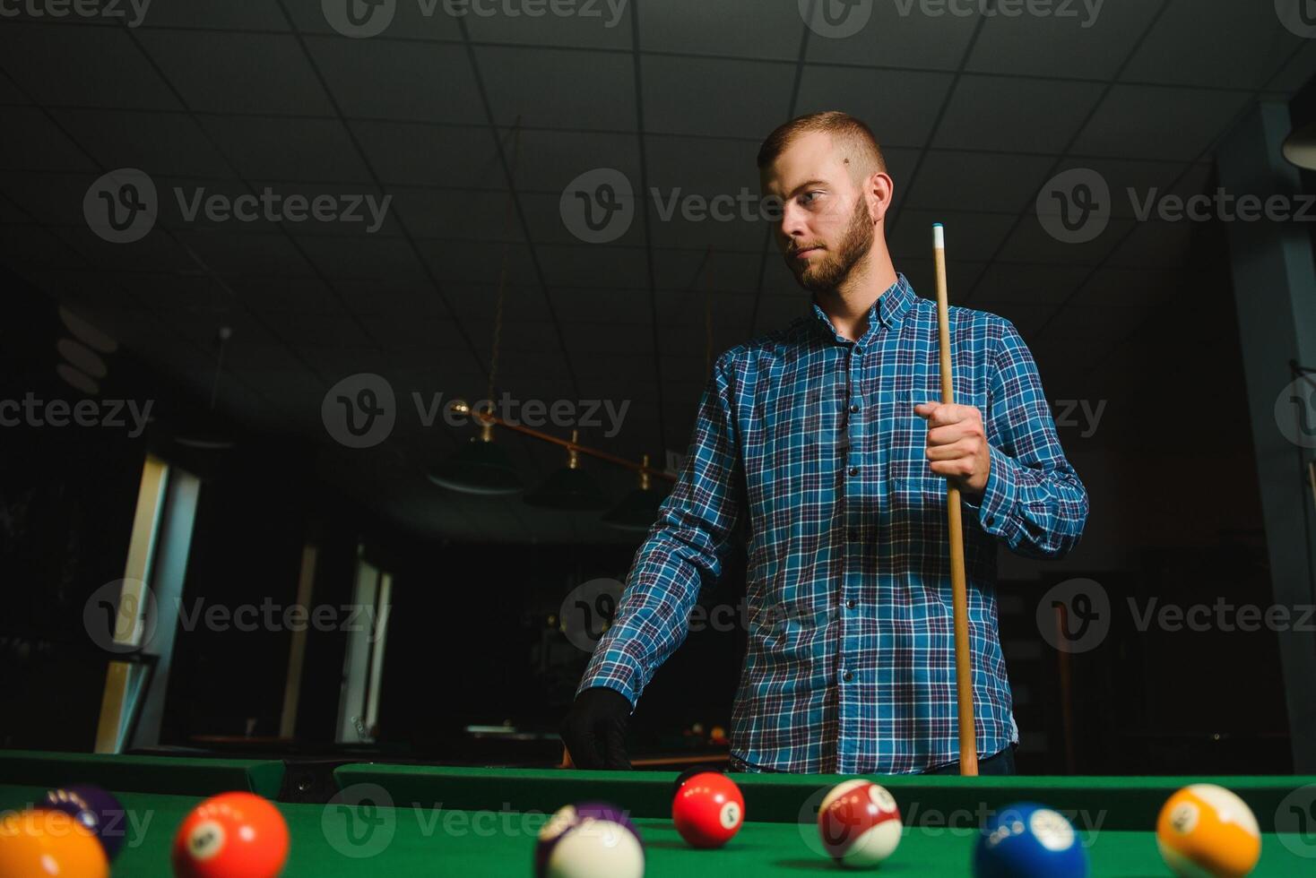 Playing billiard - Close-up shot of a man playing billiard photo