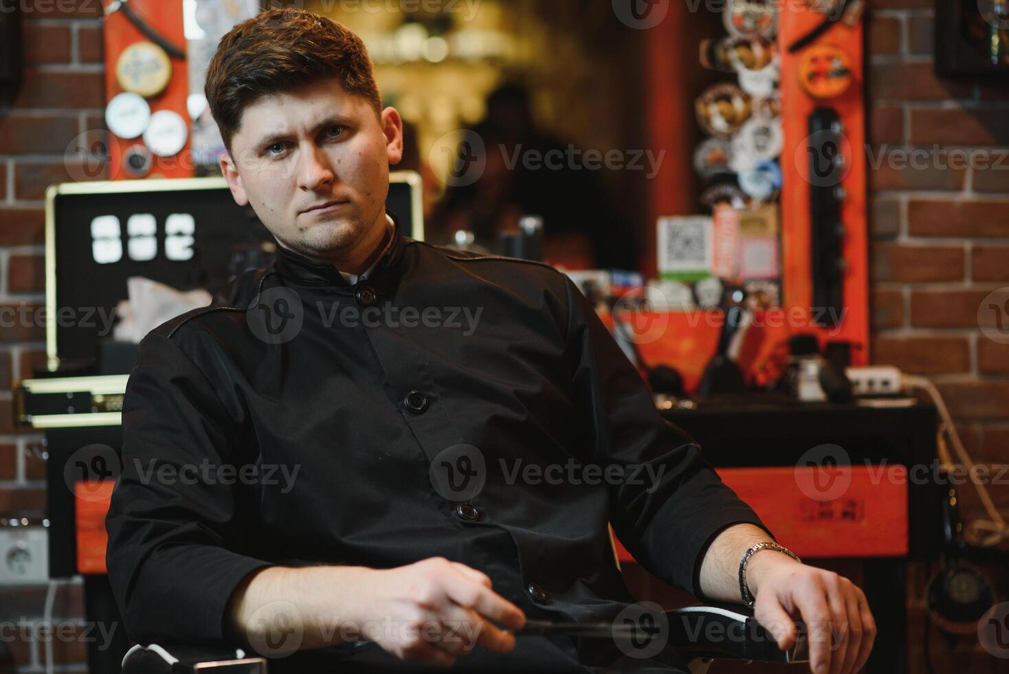 Portrait of stylish professional hairdresser with scissors. photo