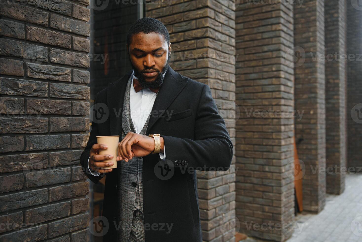 Close up portrait of a young businessman relaxing and drinking coffee in the city photo