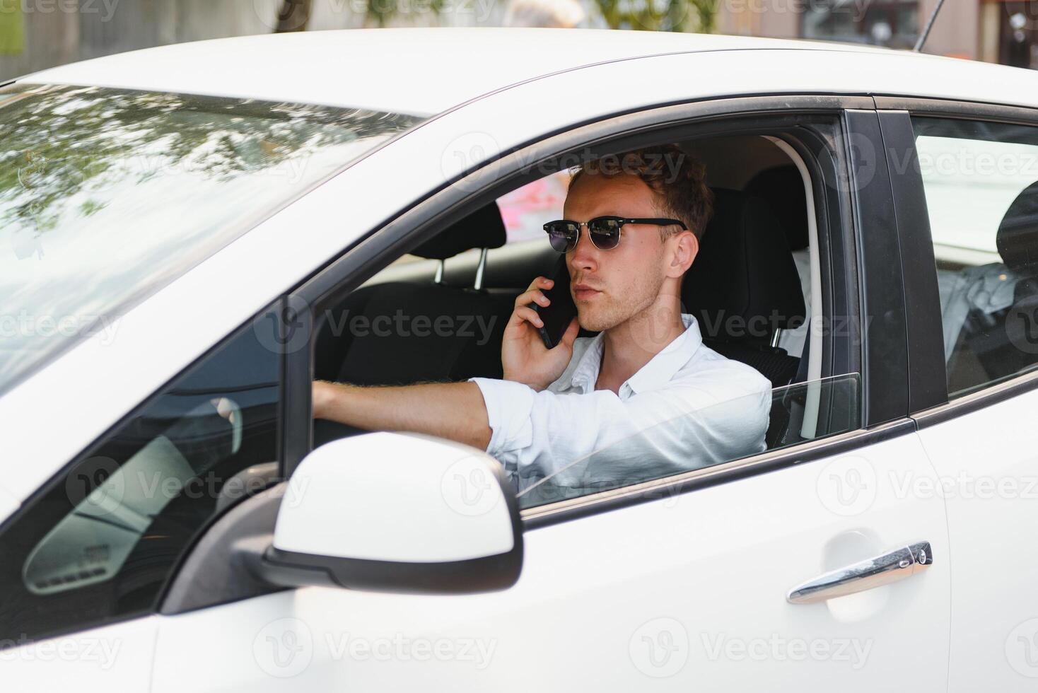 Man sitting at the wheel of electric car photo