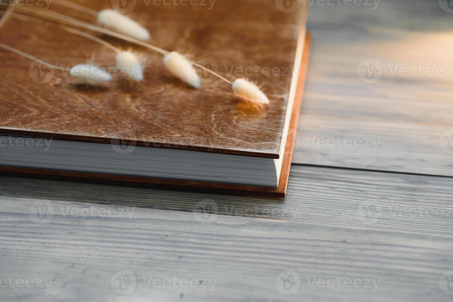 Luxury wooden photo book on natural background. Family memories photobook. Save your summer vacation memories. Photo album wedding photoalbum with wooden cover.