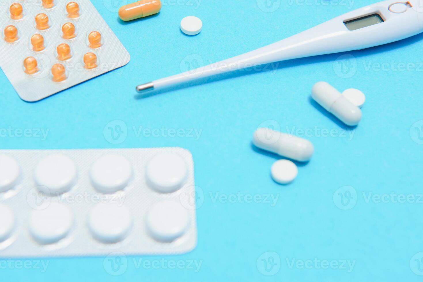 Flat lay aerial of accessories healthcare and medical background concept.Table top view stethoscope on blue paper and objects photo