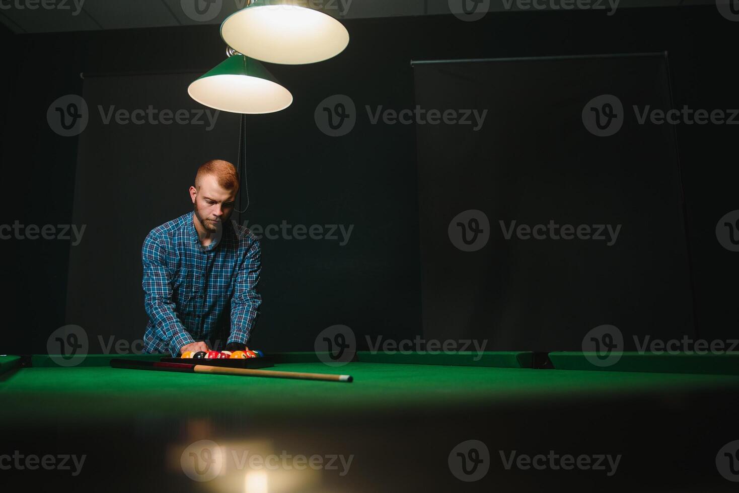 Playing billiard - Close-up shot of a man playing billiard photo