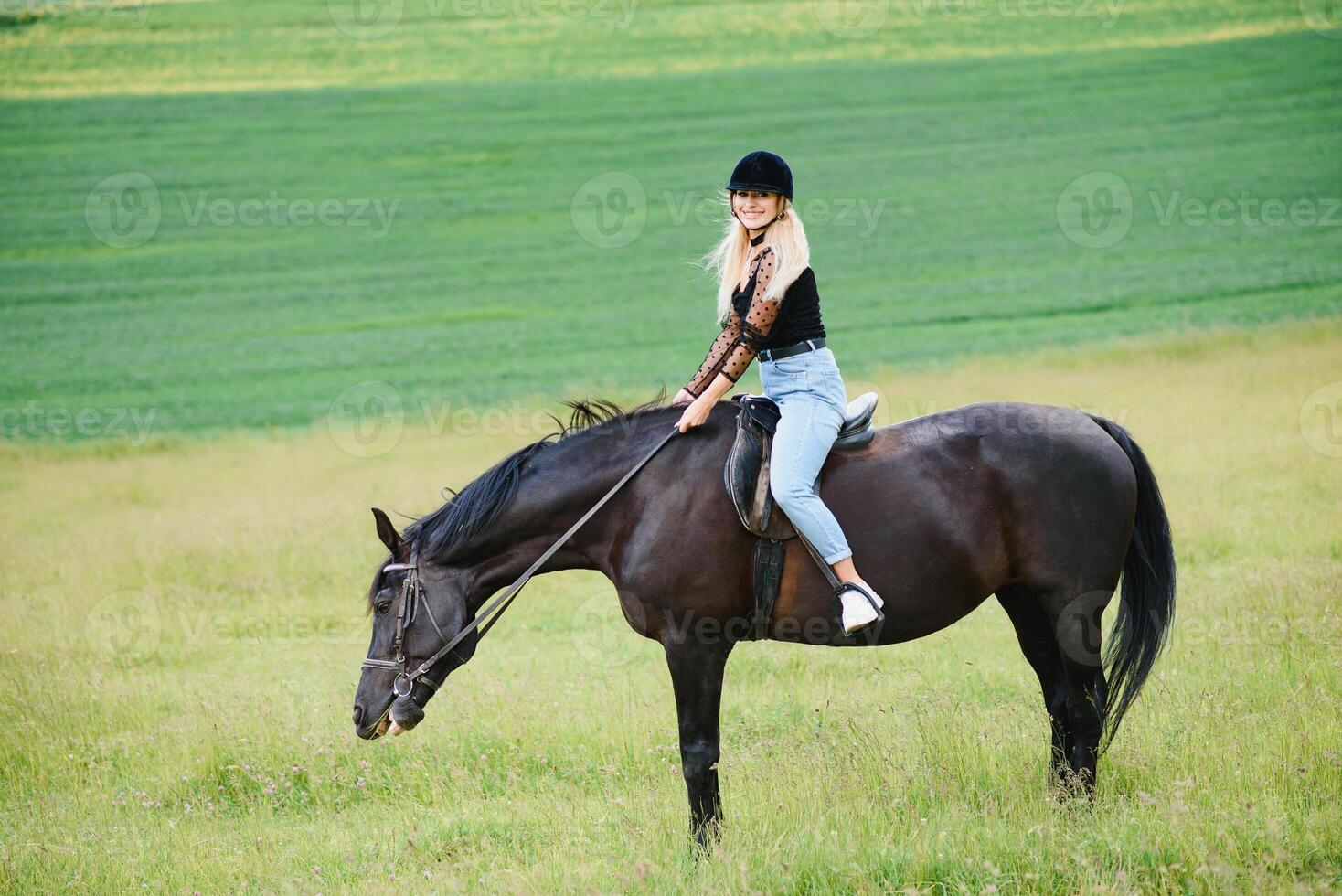 hermosa niña montando un caballo en campo. foto