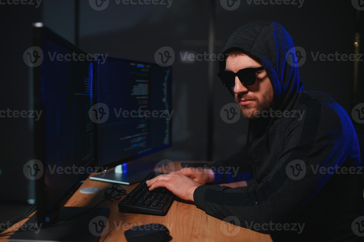 Wanted hackers coding virus ransomware using laptops and computers. Cyber attack, system breaking and malware concept photo