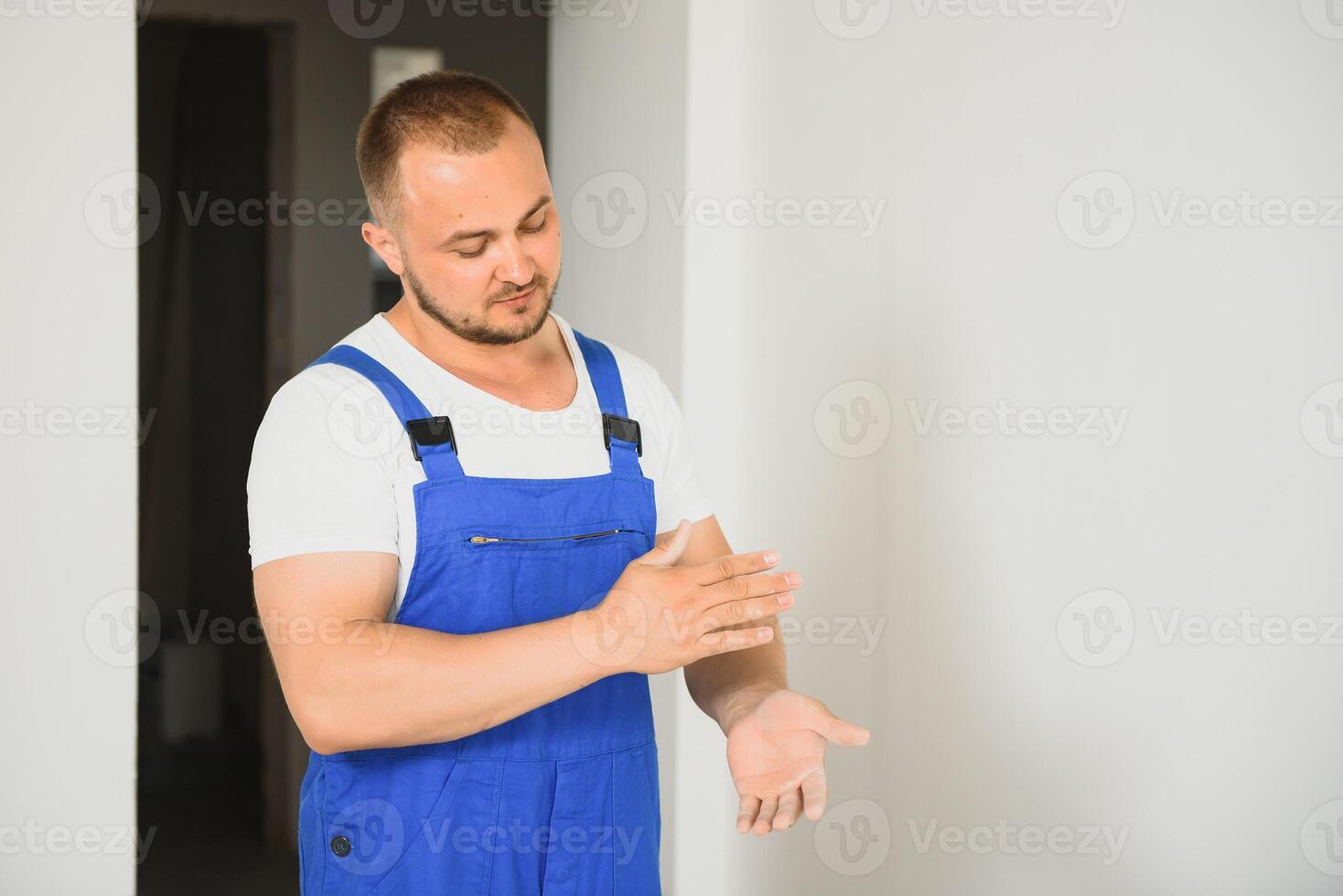 Portrait happy worker, in uniform, on white background, isolated. Repair service concept photo