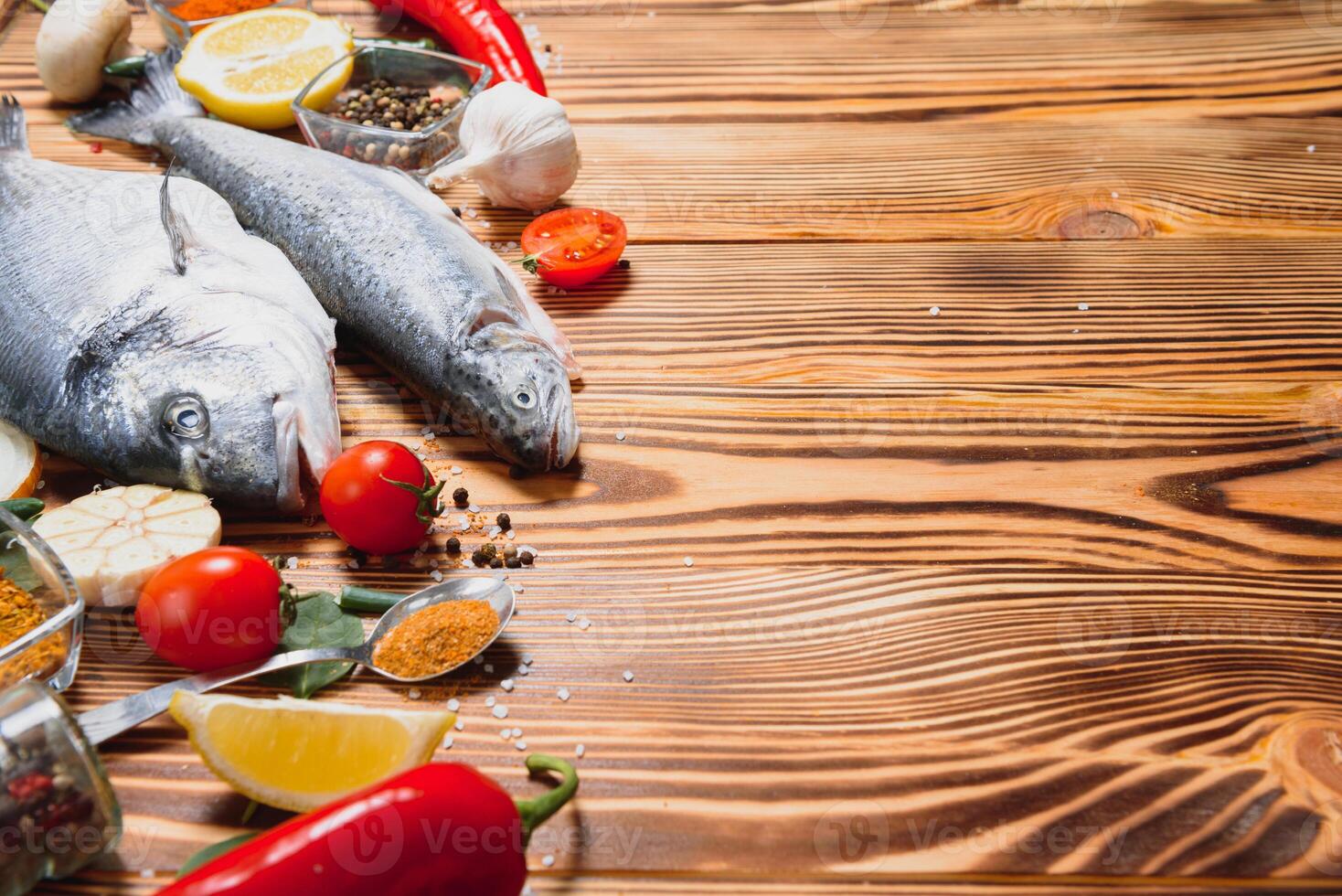 Raw dorado and trout fish with spices cooking on cutting board. Fresh fish dorado photo