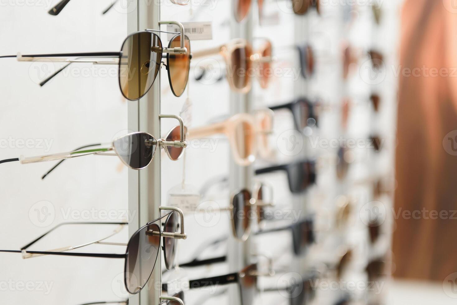 rack with glasses and sunglasses close up. photo