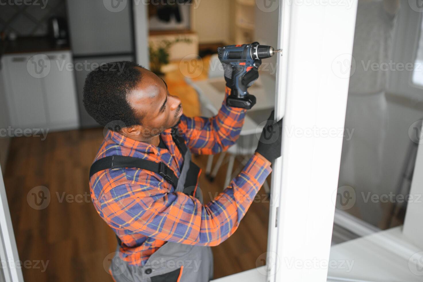 African service man installing window photo