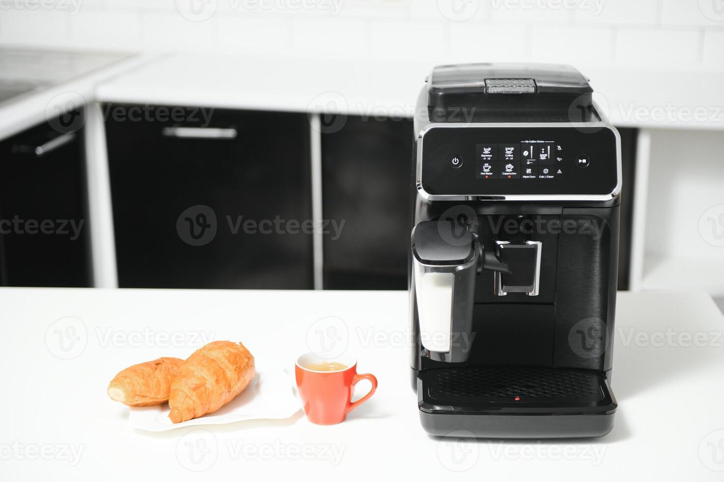 Modern coffee machine on table in kitchen photo