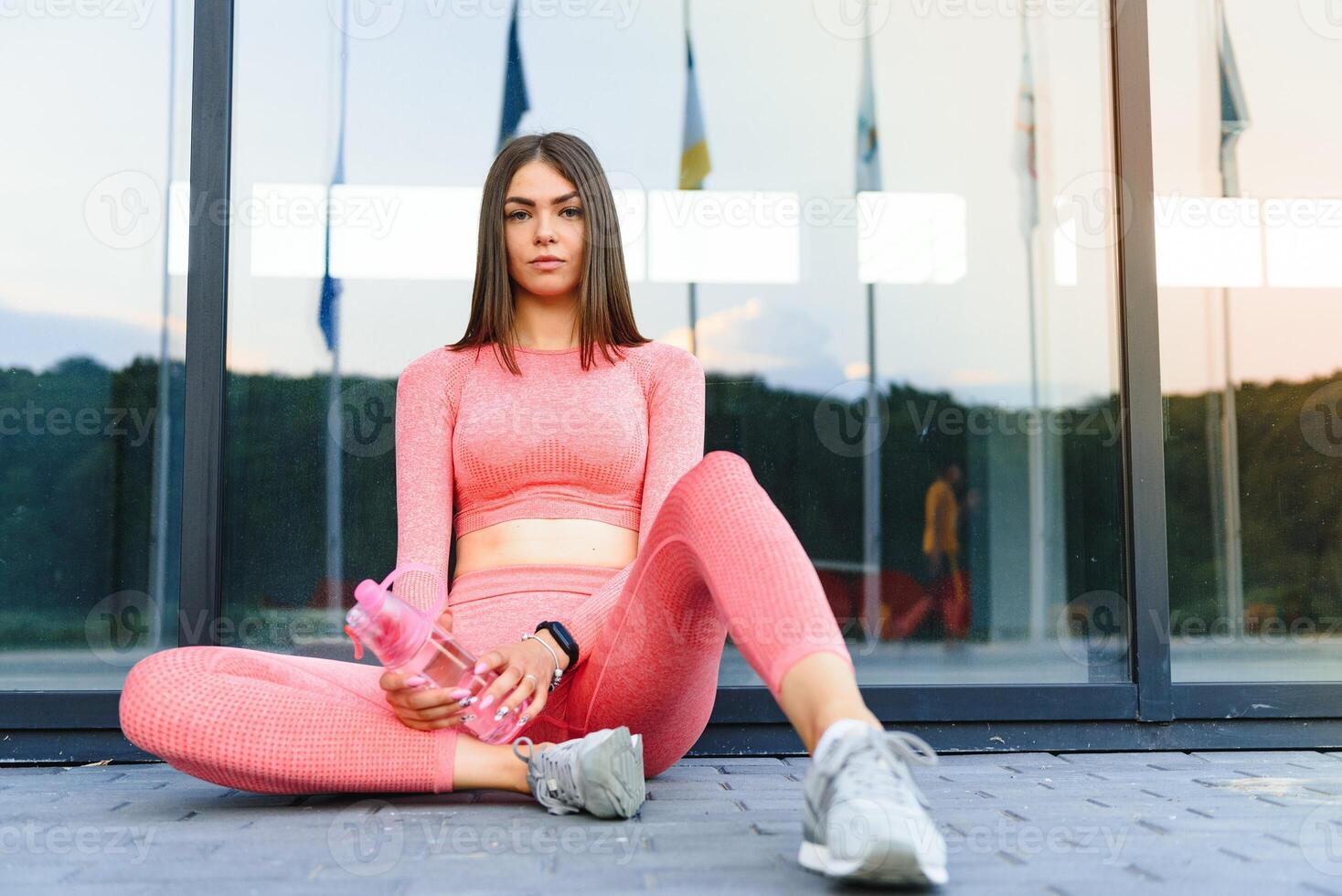 Young smiling female resting after an active fitness training. photo