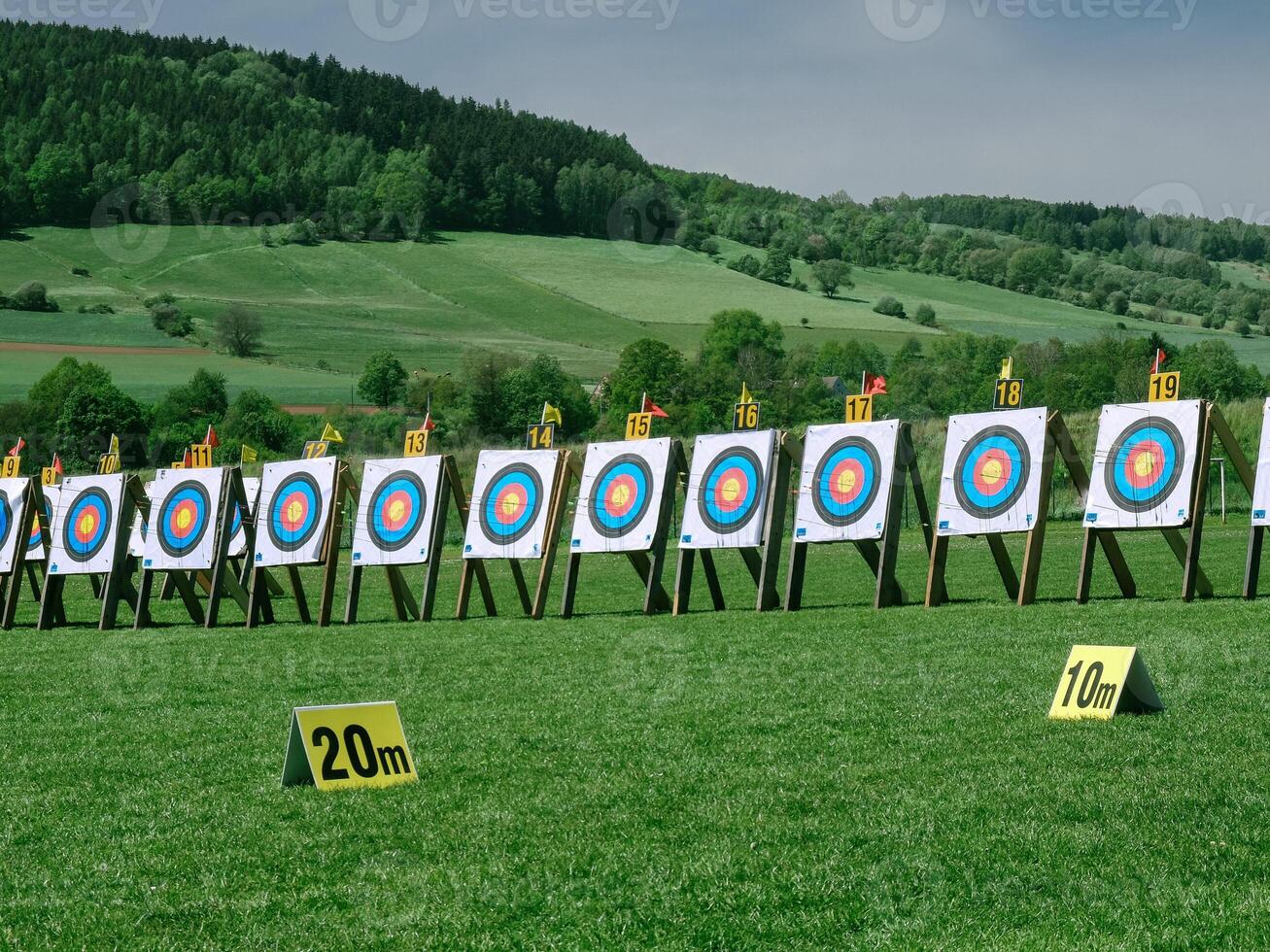 Row of training boards for archery in a field against a green background photo