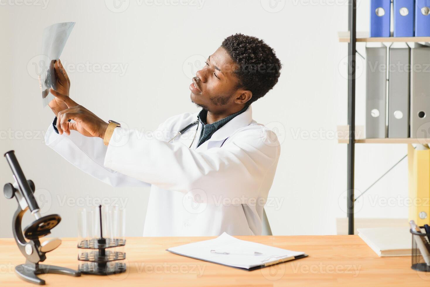 Portrait of doctor checking on X-ray results. photo