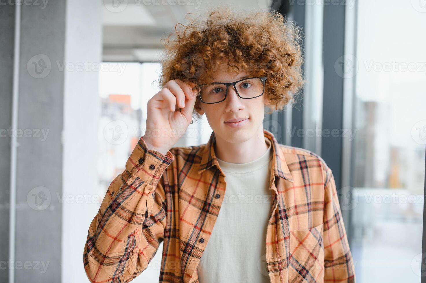 cute red-haired guy wearing stylish glasses yellow t-shirt. photo