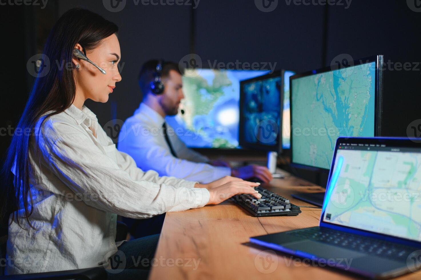 Smiling friendly female call center agent with headset working on support hotline in the office photo