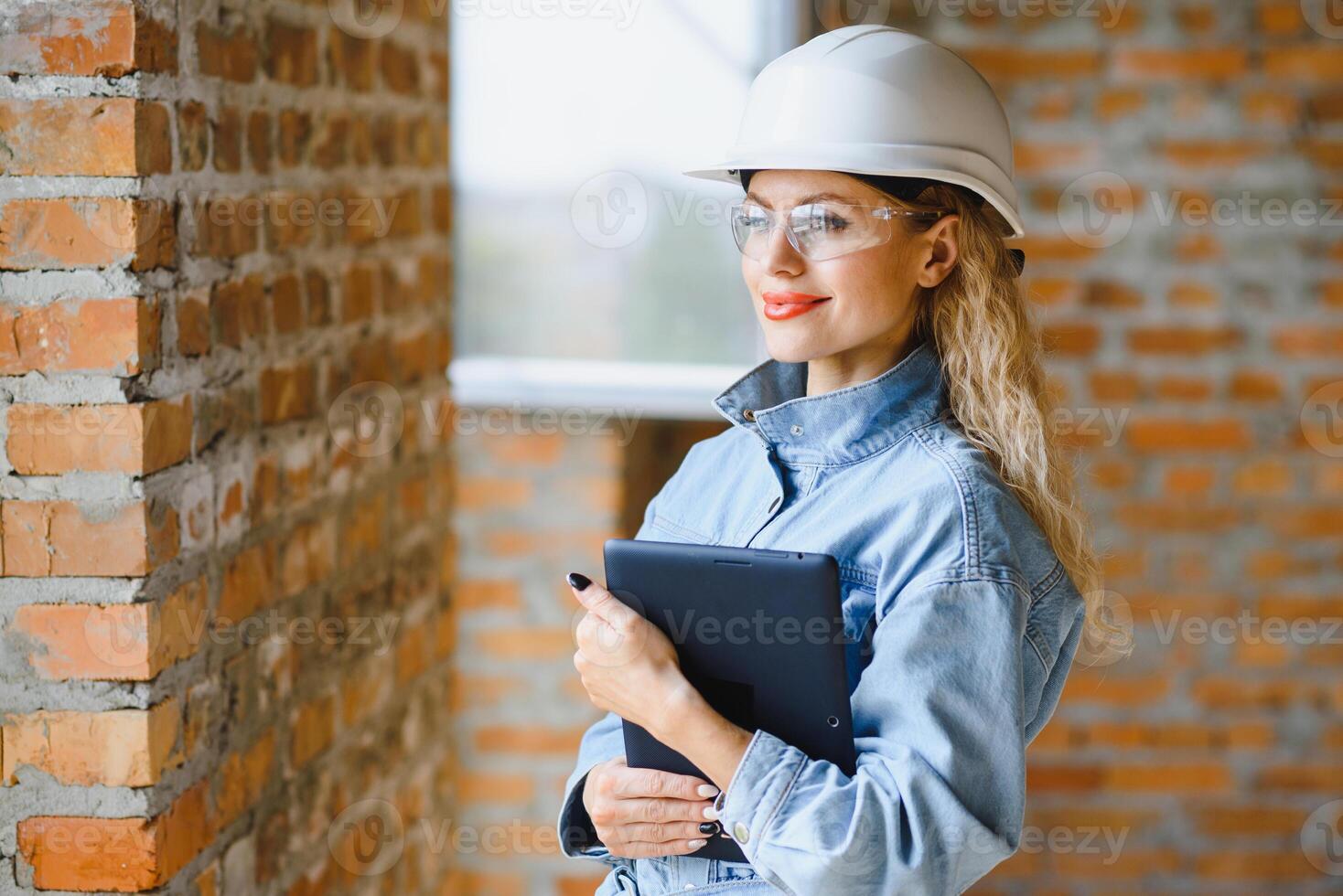 Warehouse woman worker. Woman builder in hardhat. Girl engineer or architect. Home renovation. Quality inspector. Construction job occupation. Construction worker. Lady at construction site photo