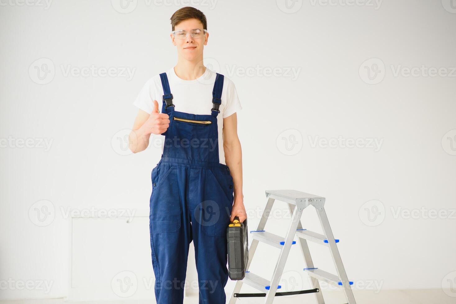 portrait of an employee making repairs in a new apartment photo