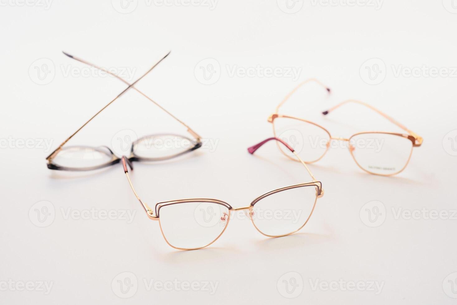 Stylish eyeglasses over background. Optical store, glasses selection, eye test, vision examination at optician, fashion accessories concept. Top view, flat lay photo