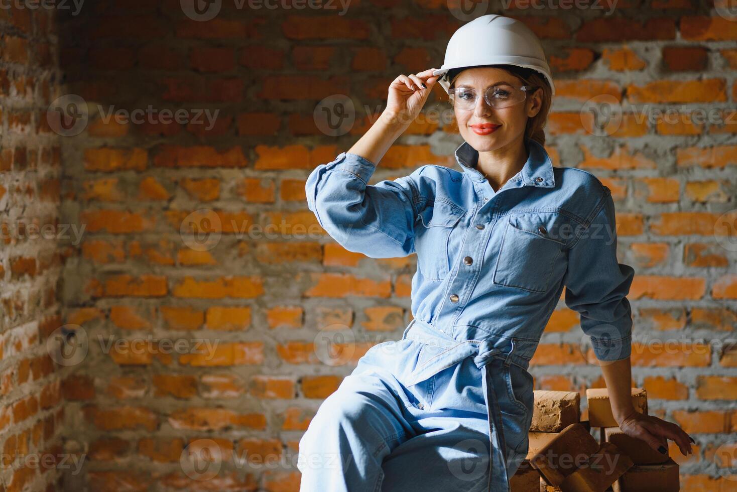 Warehouse woman worker. Woman builder in hardhat. Girl engineer or architect. Home renovation. Quality inspector. Construction job occupation. Construction worker. Lady at construction site photo