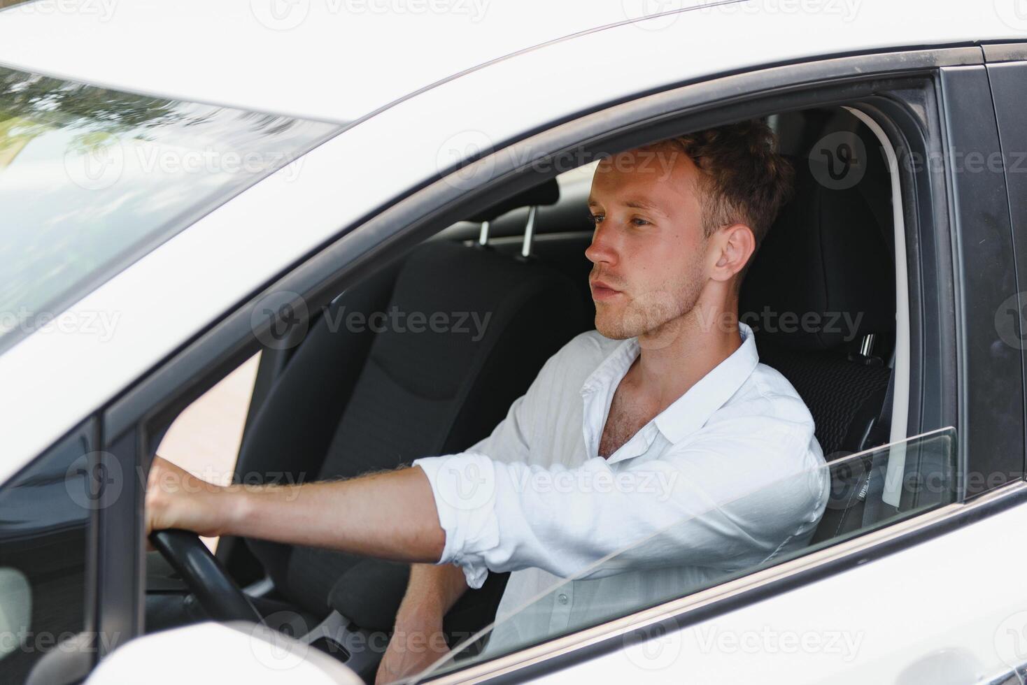 Man sitting at the wheel of electric car photo