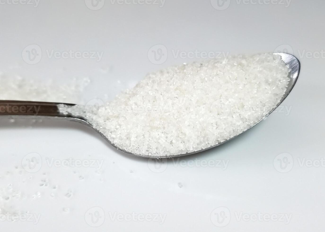 teaspoon sugar isolated on white background photo