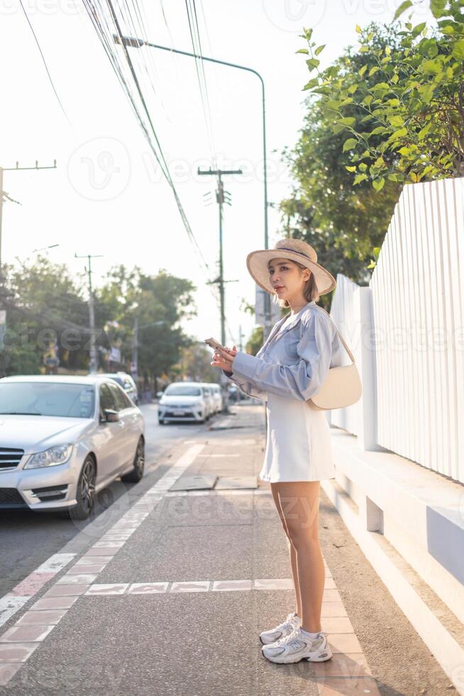 Traveler Asian woman traveling and walking in Bangkok Chiang Mai Temple, Thailand, backpacker female feeling happy spending relax time in holiday trip photo