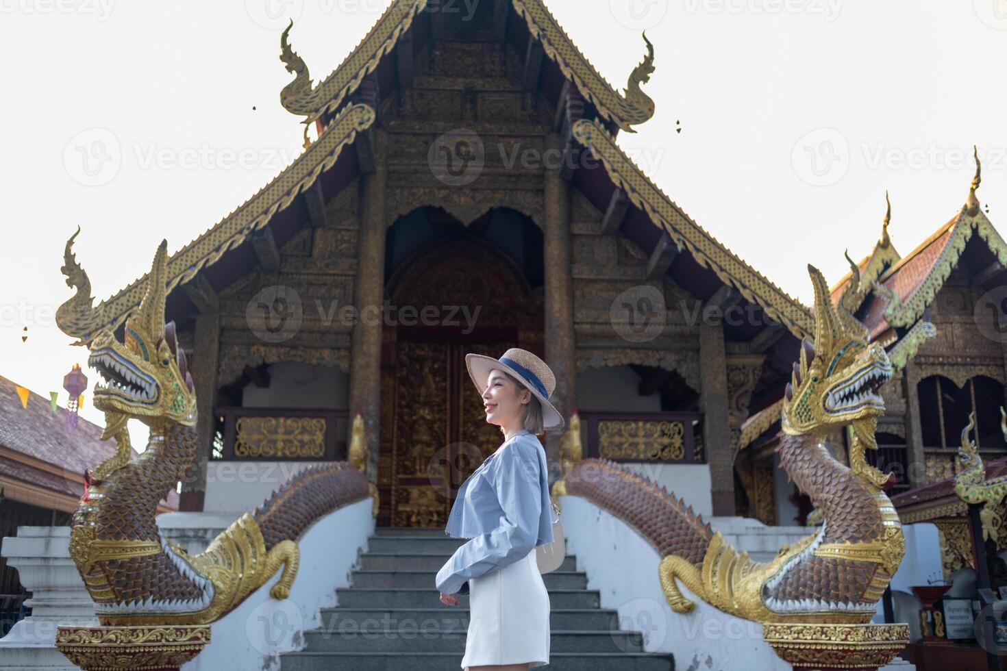Traveler Asian woman traveling and walking in Bangkok Chiang Mai Temple, Thailand, backpacker female feeling happy spending relax time in holiday trip photo