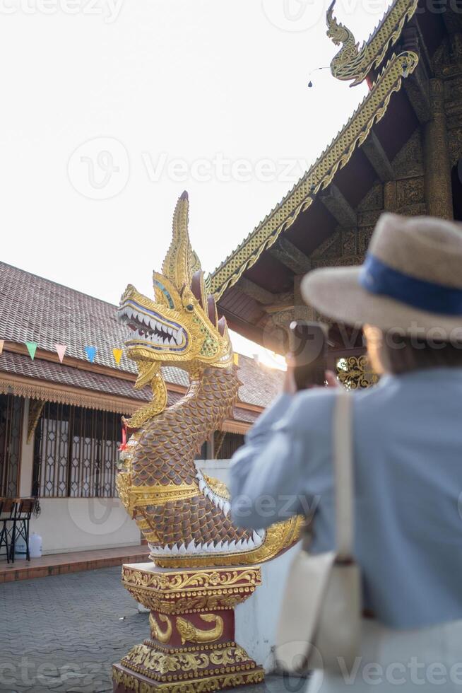 Traveler Asian woman traveling and walking in Bangkok Chiang Mai Temple, Thailand, backpacker female feeling happy spending relax time in holiday trip photo
