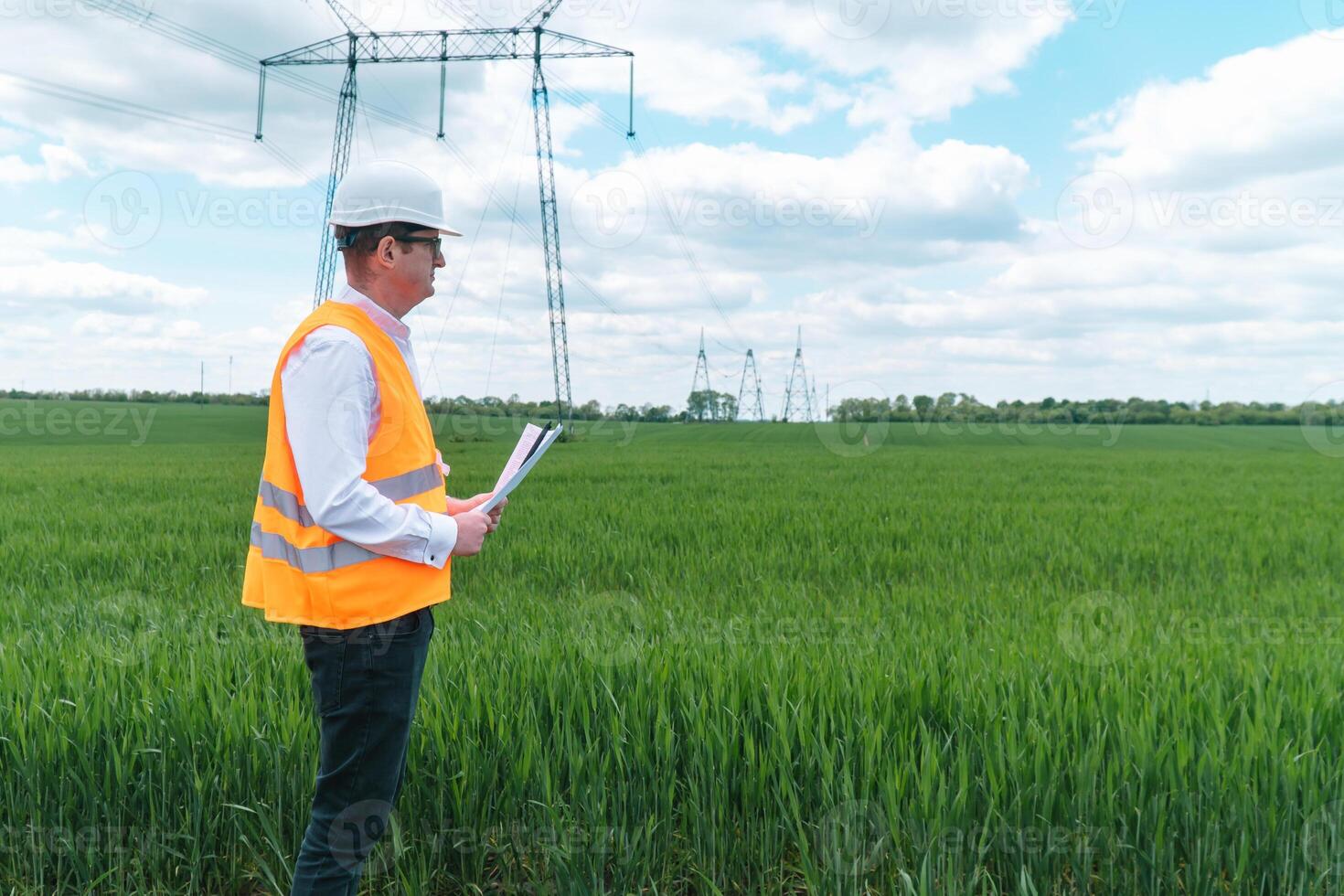 Engineer working near transmission lines. Transmission towers photo