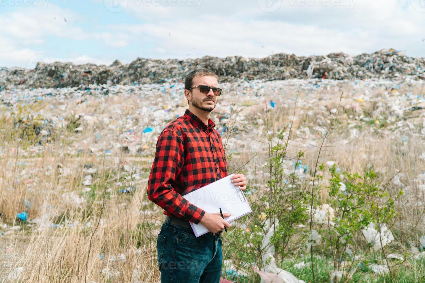 Garbage dump inspector records pollution level. Ecology pollution concept. Save planet photo