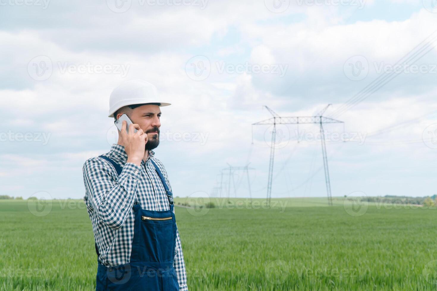 Engineer working near transmission lines. Engineer working near transmission lines. Transmission towers photo