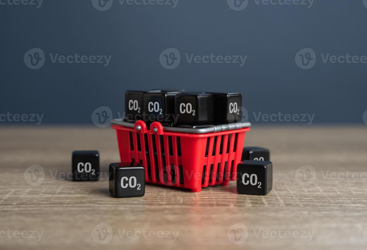 Shopping basket and cubic CO2 gas. Carbon footprint of product consumers. Industrial emissions quotas. Limit the total amount of greenhouse gases companies can emit, aiming to reduce climate change. photo