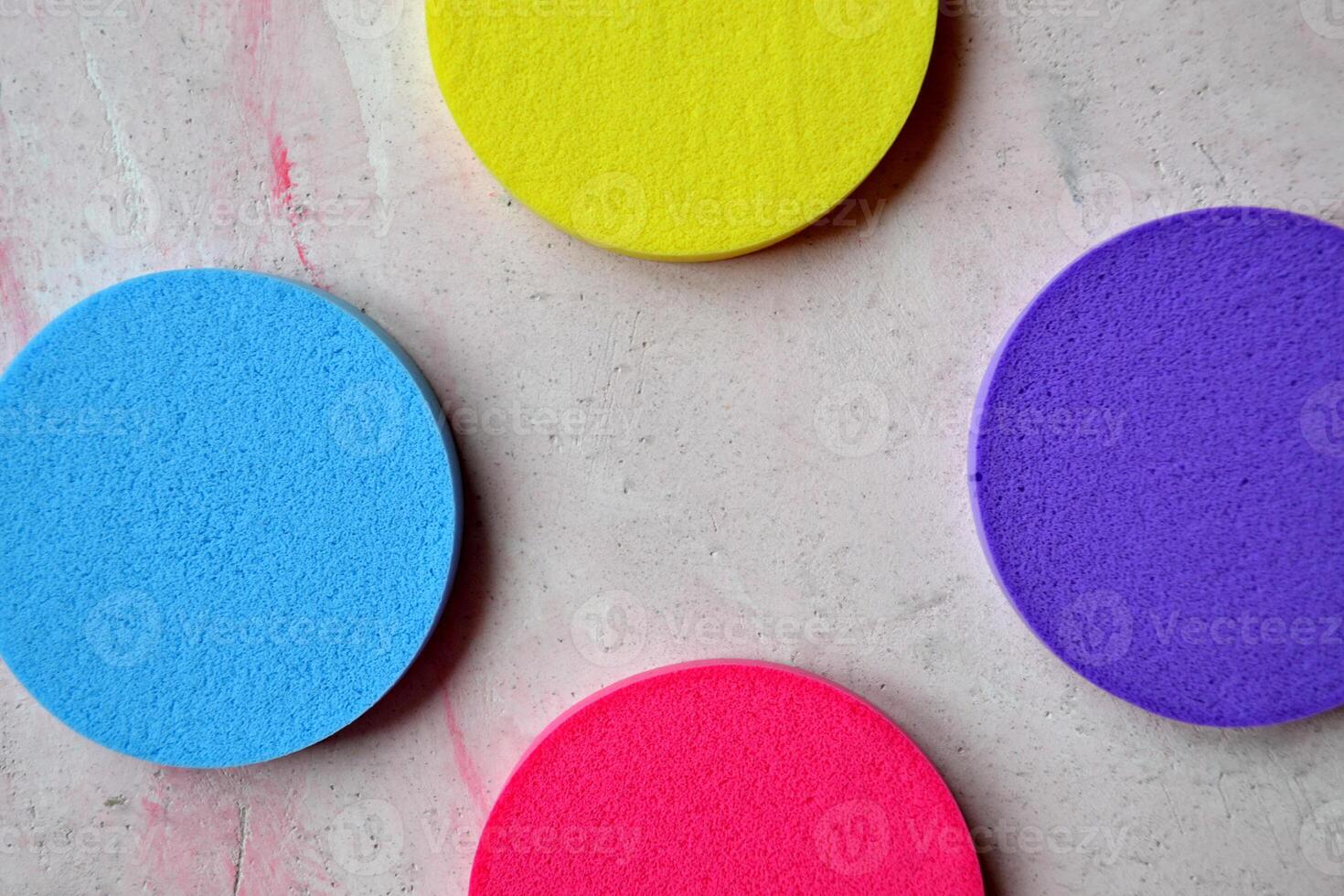 Colorful sponges on textured desk. Bright abstract background. photo