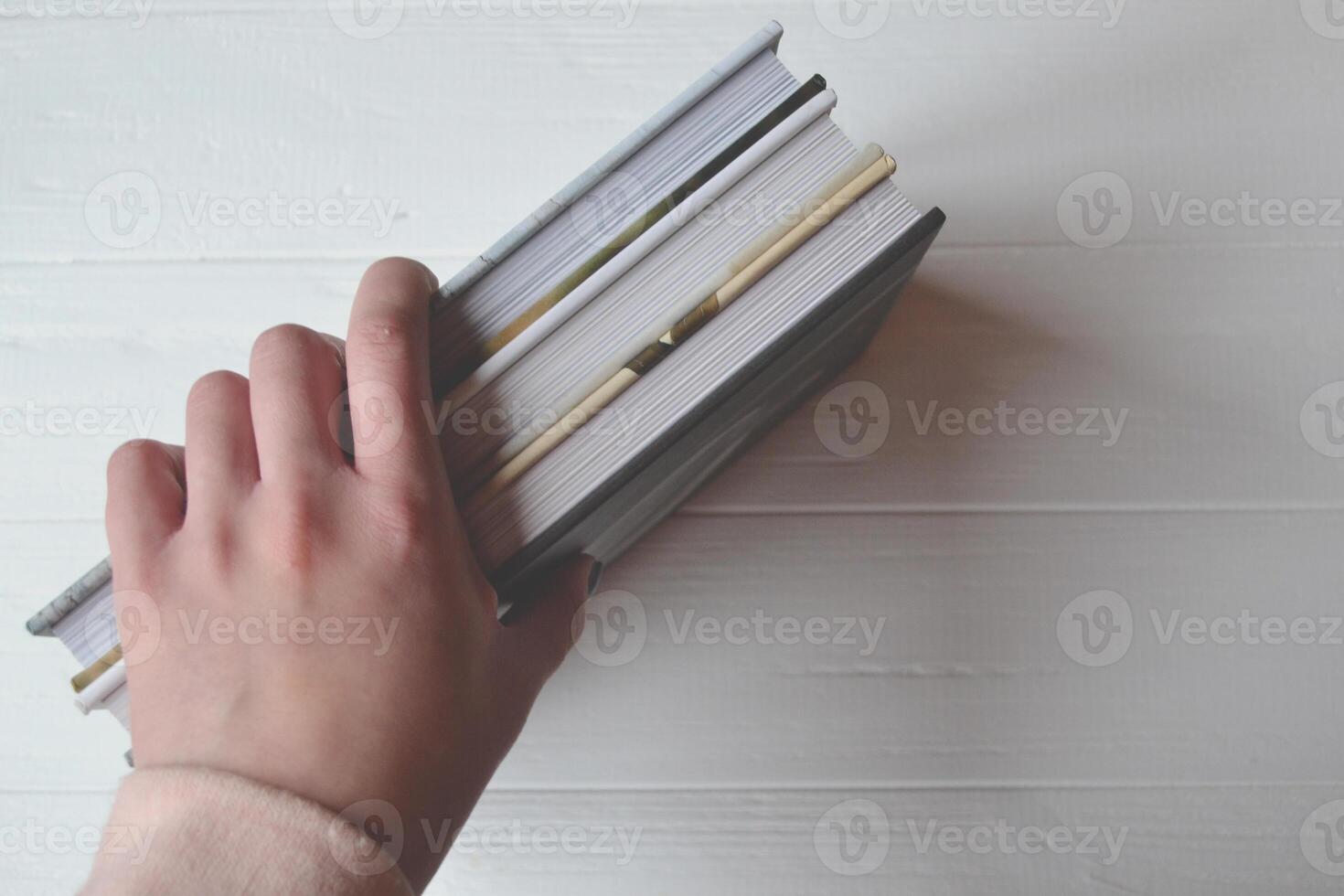 Books in the woman hand on the white background. photo