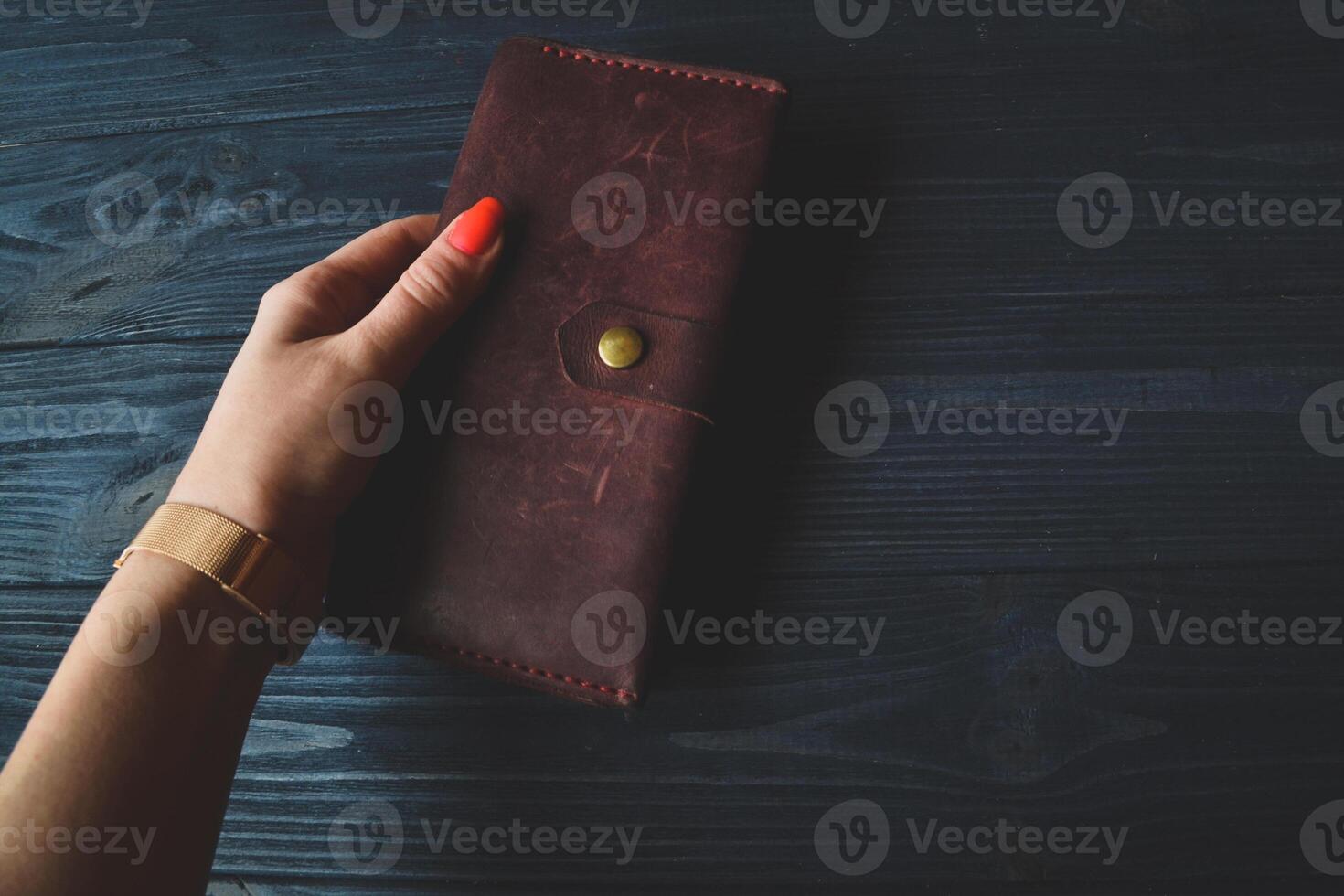 Vintage wallet in beautiful female hand. Wallet with money in hand of successful woman. photo