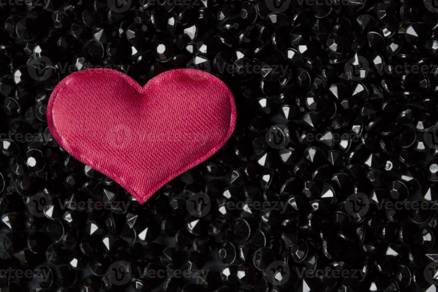Red heart on a black rhinestones. photo
