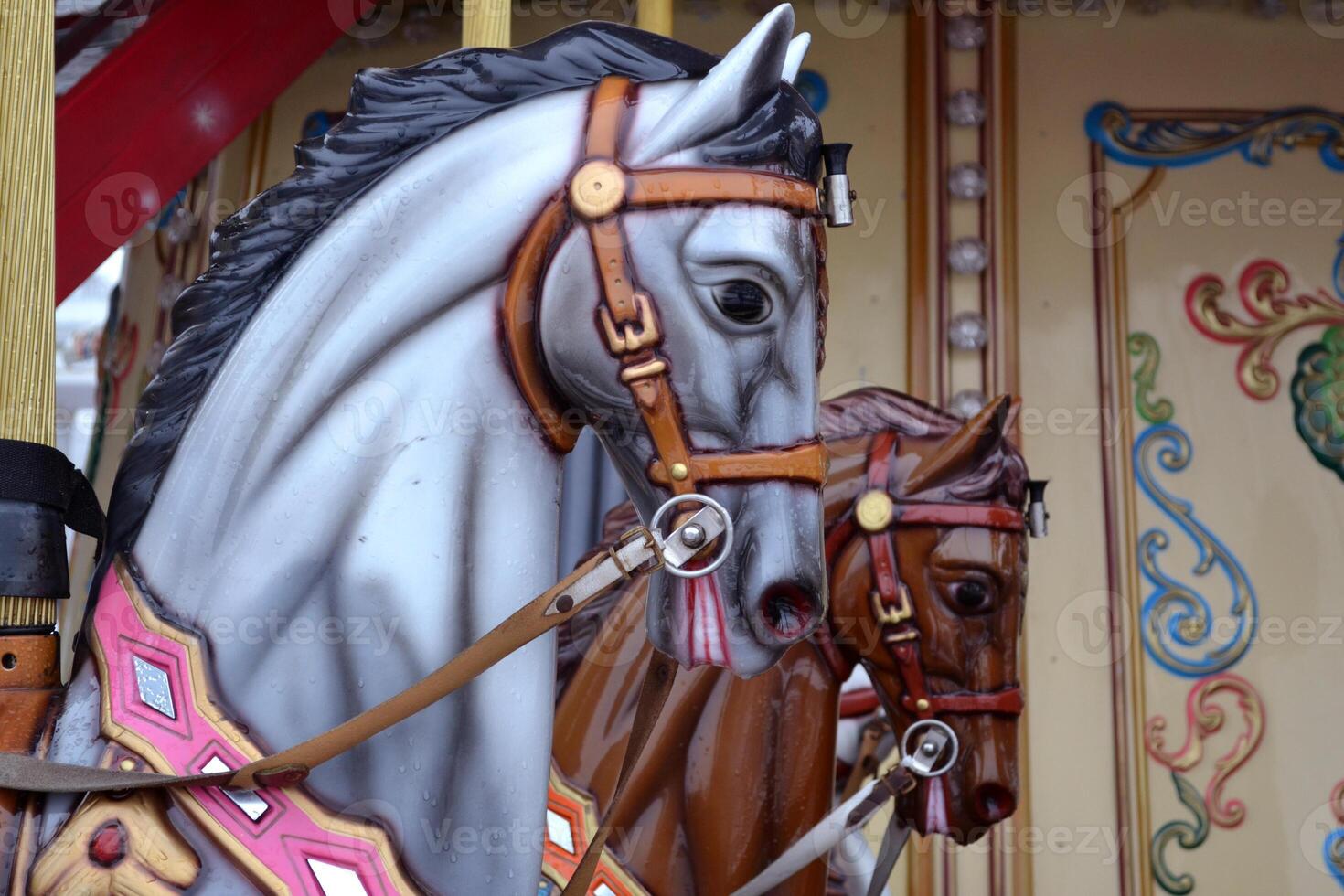 Vintage european carousel in a park. Merry go round horses. Retro style carousel. photo