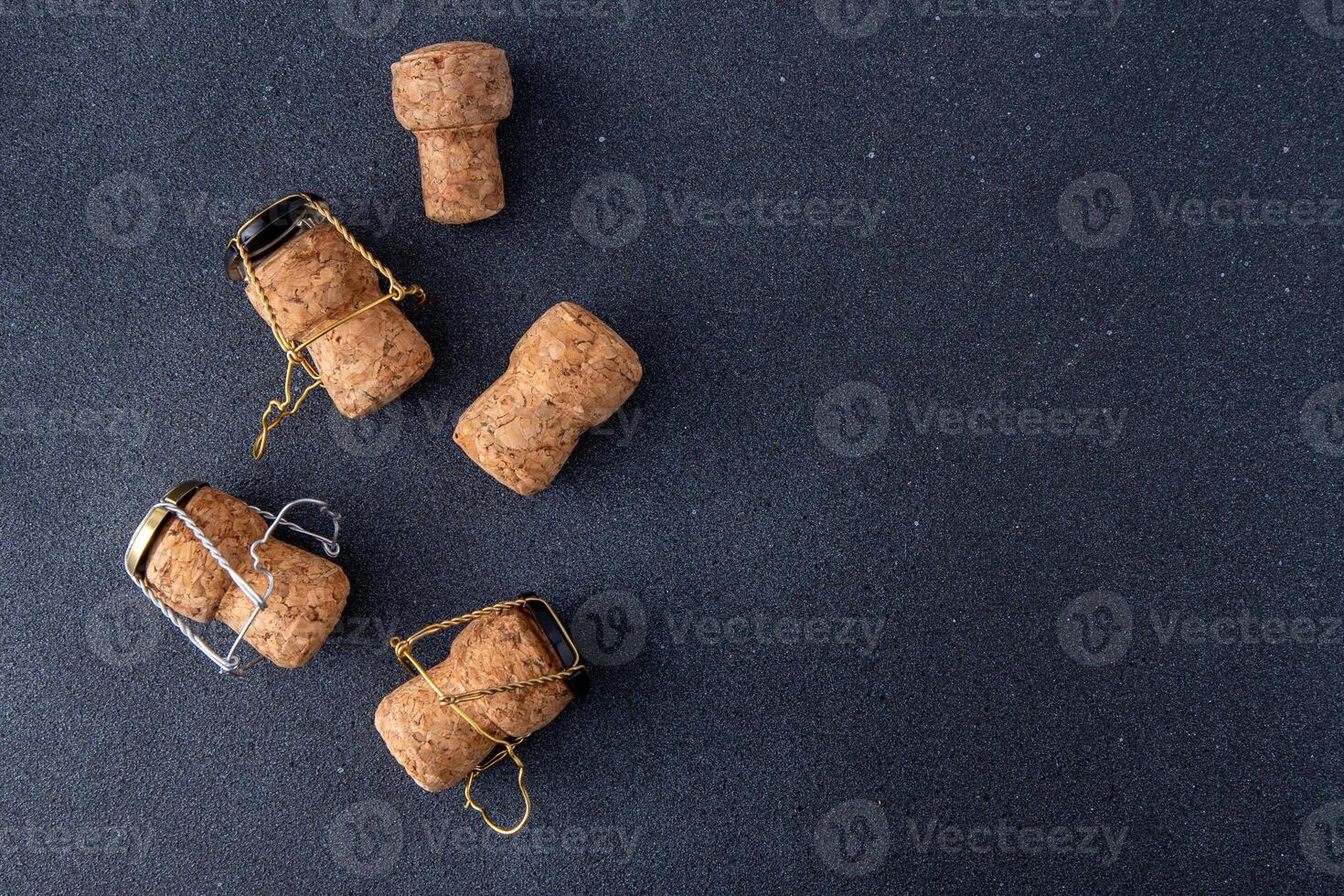 Champagne corks and metal mesh. Dark wine background photo