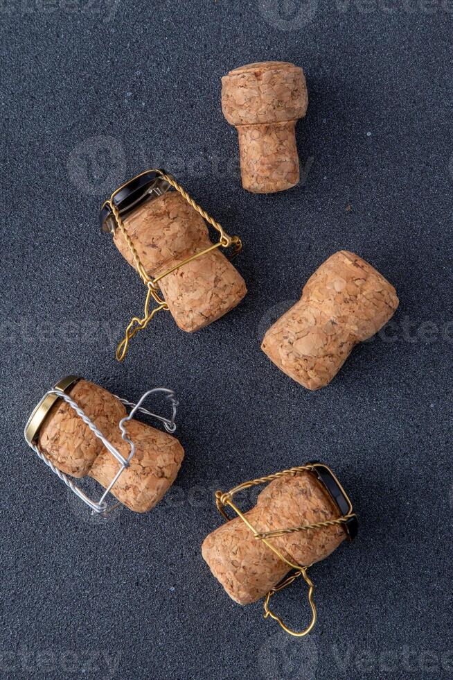 Champagne corks and metal mesh. Dark wine background photo