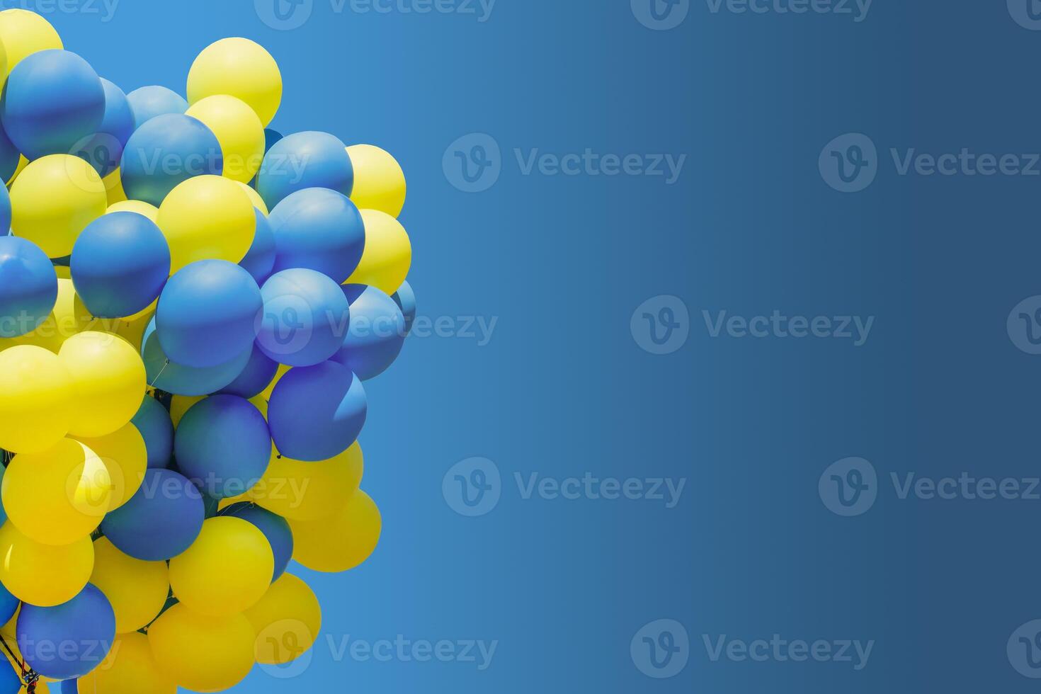 Yellow and blue balloons. Big bunch of balls. Balloon background with place for text. photo