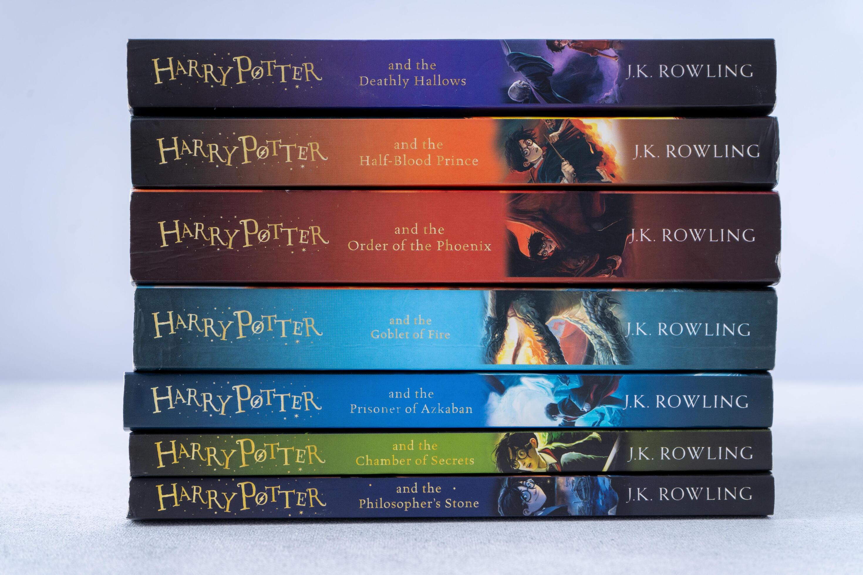 A stack of books about Harry Potter by writer JK Rowling. Collection ...